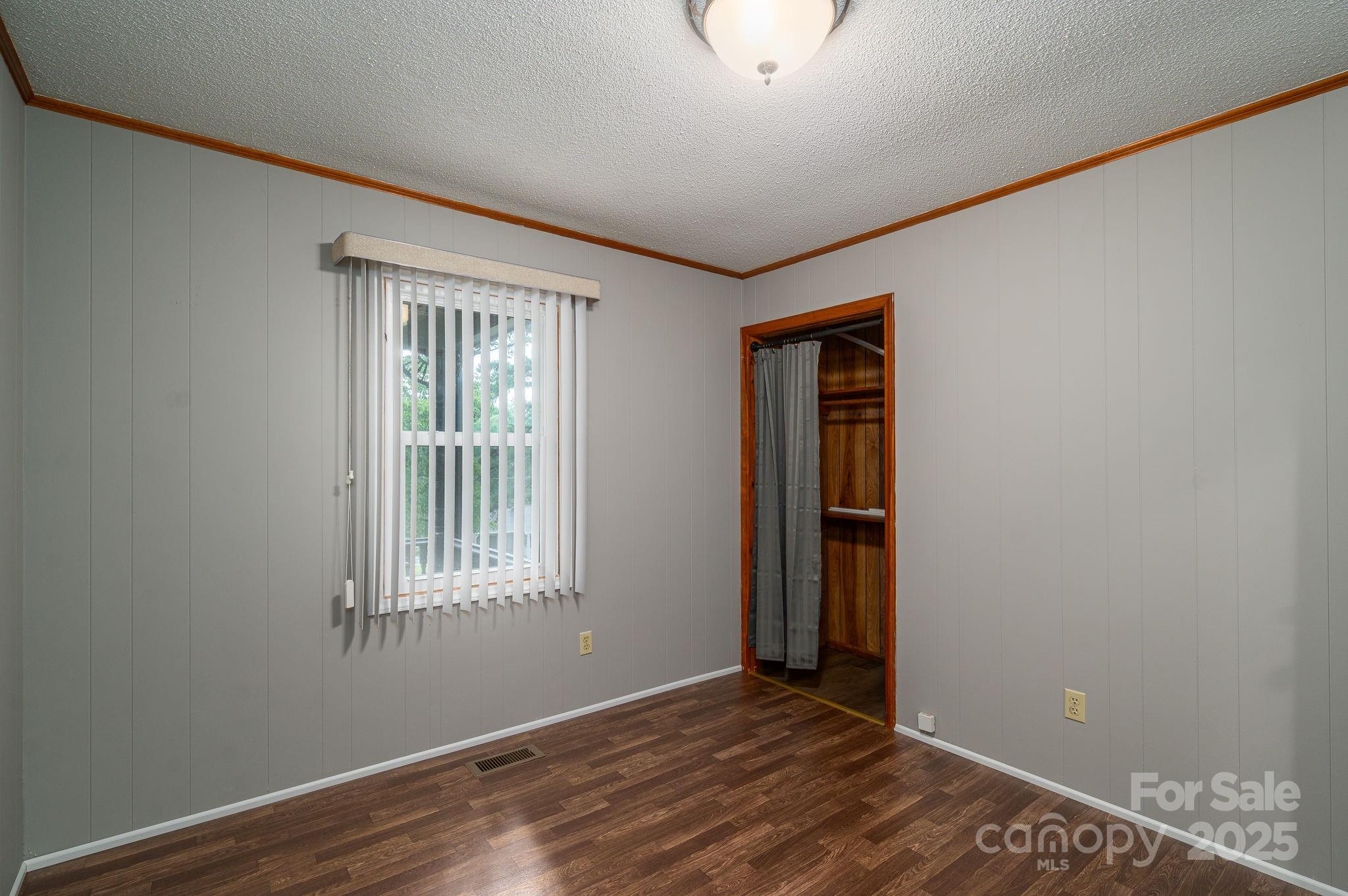 3076 Gates Road Lincolnton, NC 28092 - Photo 14 of 36 an empty room with wooden floor and windows
