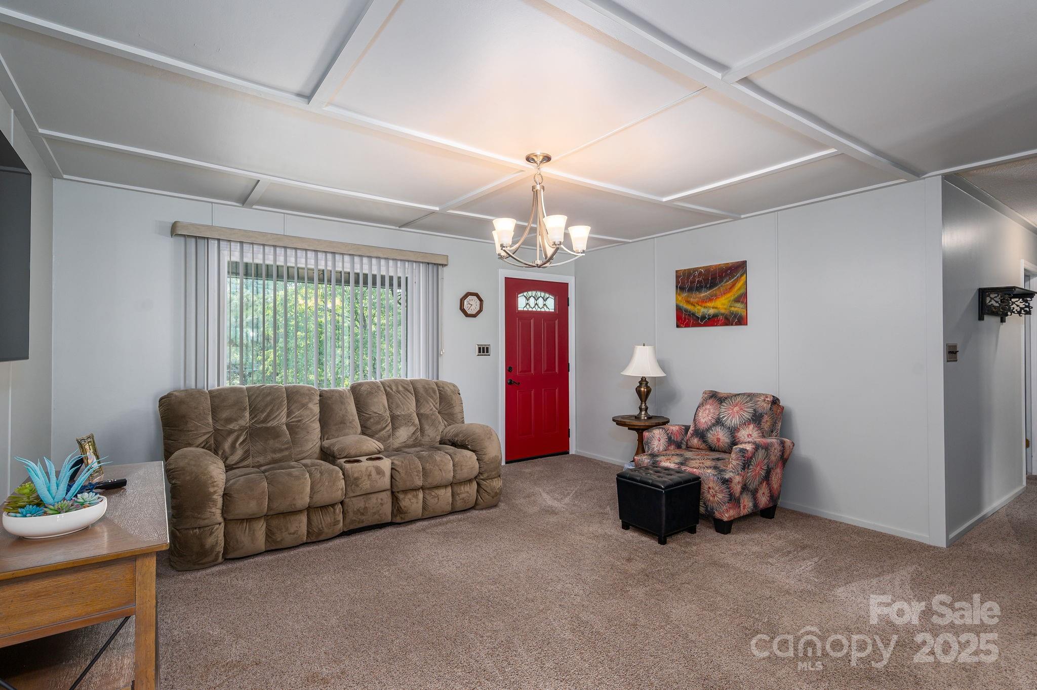3076 Gates Road Lincolnton, NC 28092 - Photo 4 of 36 a living room with furniture and a chandelier