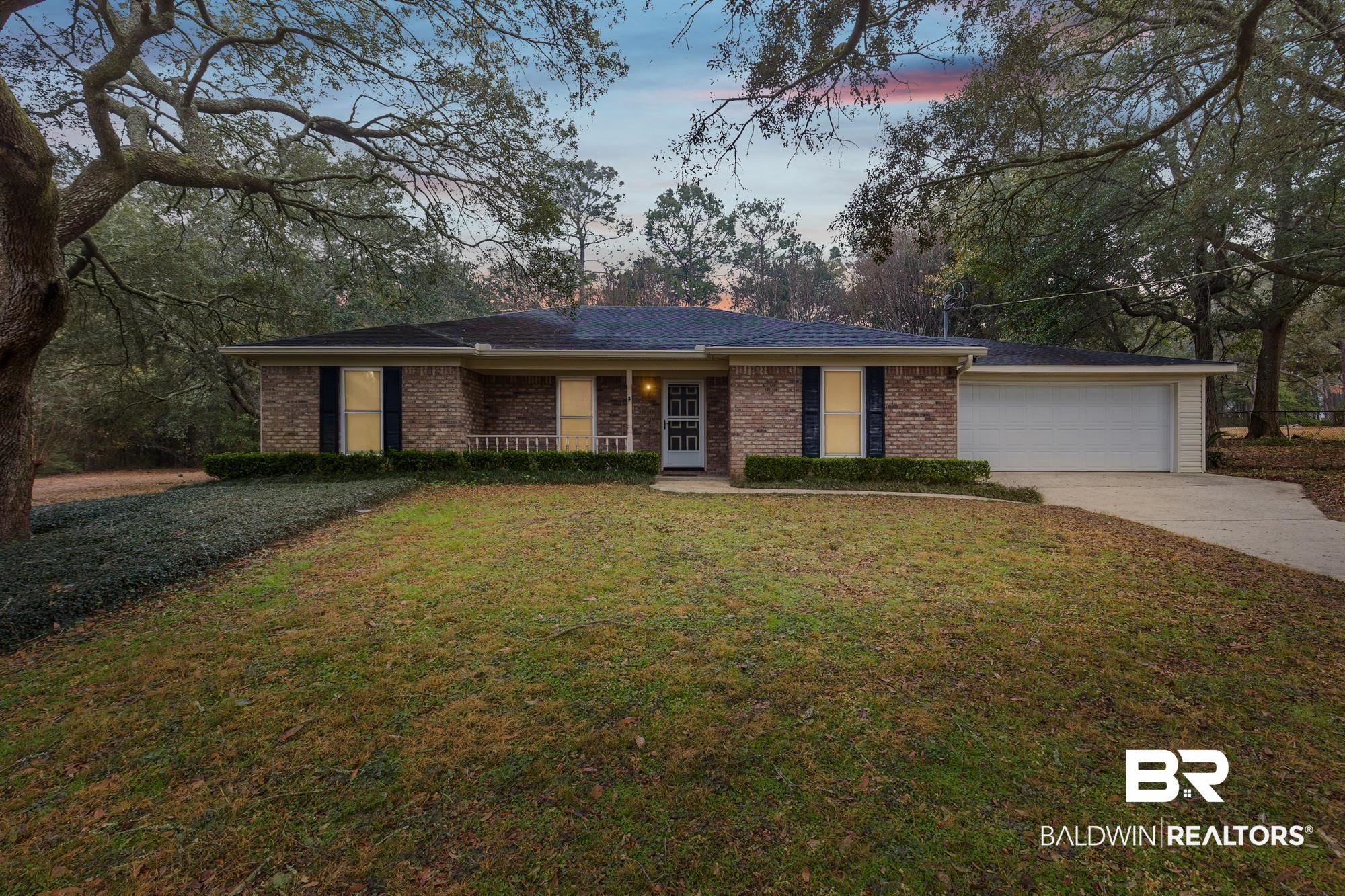 7345 Spaceview Drive Saraland, AL 36571 - Photo 1 of 22 Ranch-style house featuring a front yard, concrete driveway, brick siding, and an attached garage