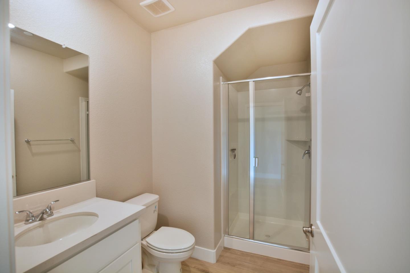 809 Big Range Way Rocklin, CA 95765 - Photo 12 of 31 a bathroom with a granite countertop sink toilet a mirror and shower