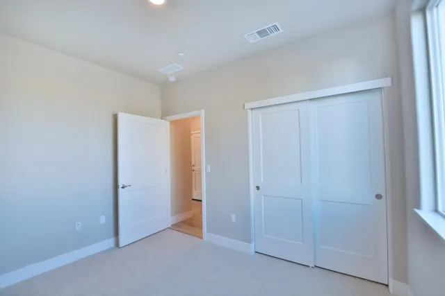 an empty room with closet area