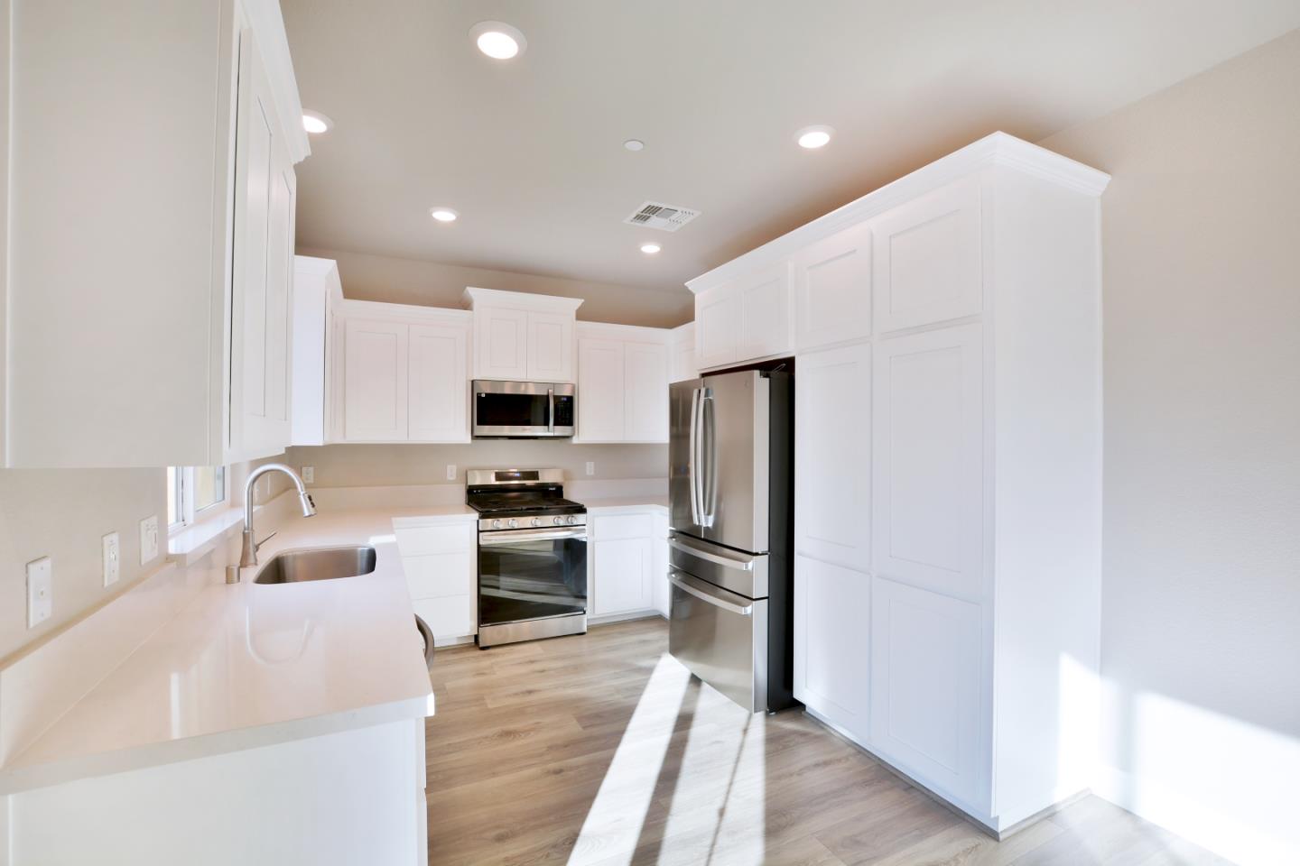 809 Big Range Way Rocklin, CA 95765 - Photo 9 of 31 a kitchen with stainless steel appliances granite countertop a refrigerator and a sink