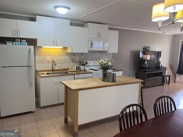 a kitchen with a refrigerator and a sink