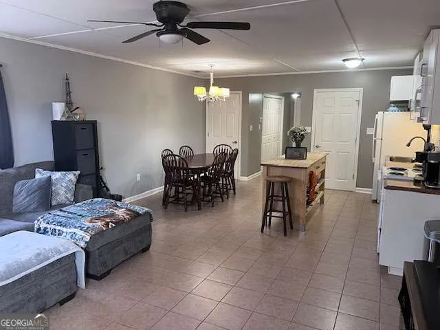 a living room with furniture and a dining table with projector