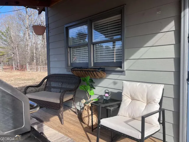 a view of a chairs and table in the back yard of the house