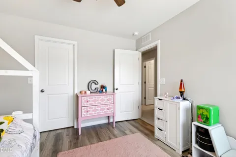 a bedroom with furniture and a wooden floor