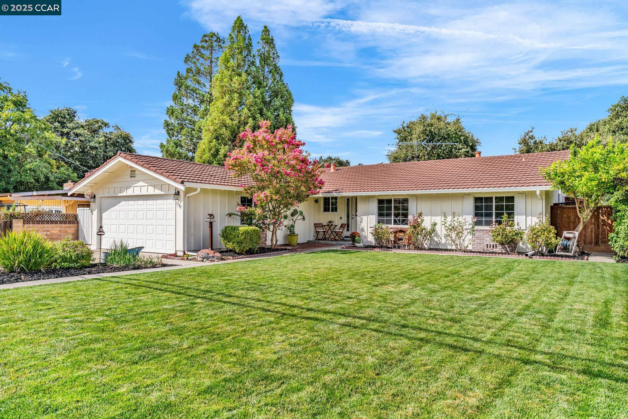 a front view of a house with a garden