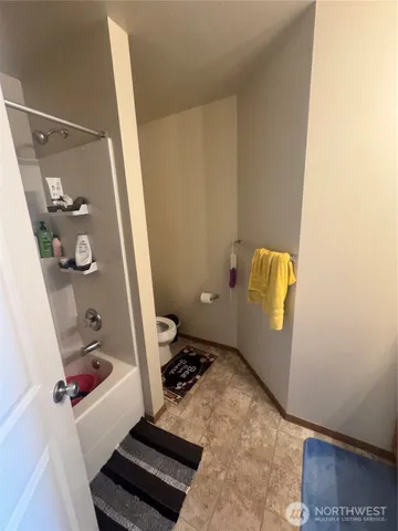 a bedroom with a bed and a desk