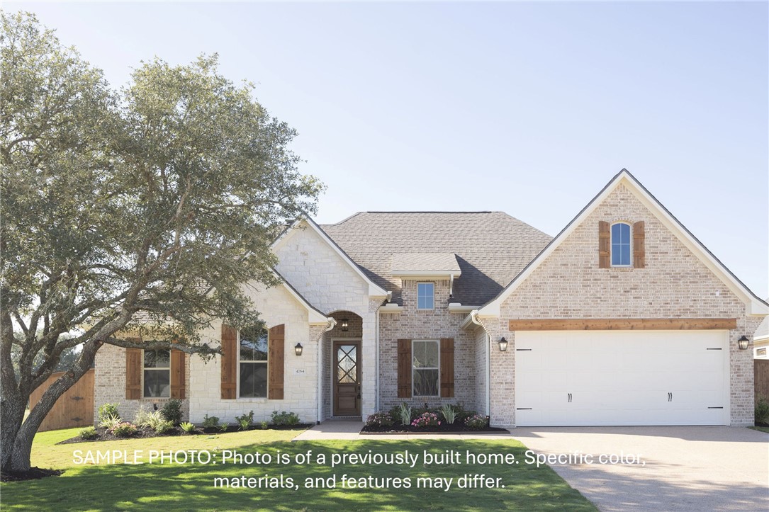 7020 Skipping Rock Path Bryan, TX 77808 - Photo 2 of 19 a front view of a house with garden
