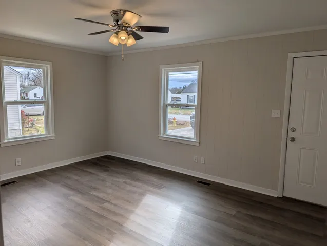 a view of a room with wooden floor closet and windows