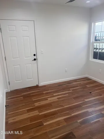 a view of room with window and hardwood floor