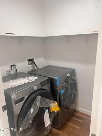 a utility room with two washing machine