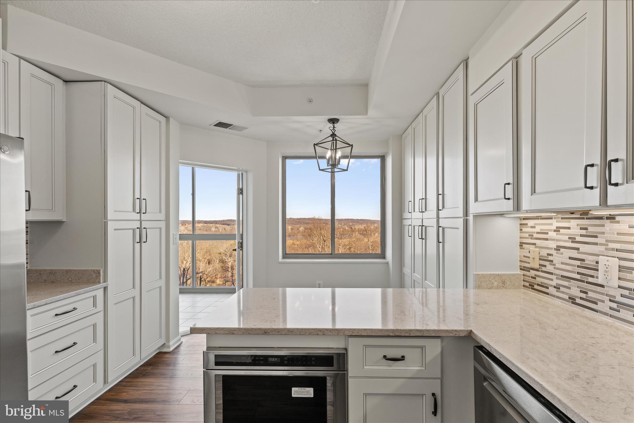 19355 Cypress Ridge Terrace, Unit 612 Leesburg, VA 20176 - Photo 17 of 64 Beautiful views from kitchen and access to sunroom