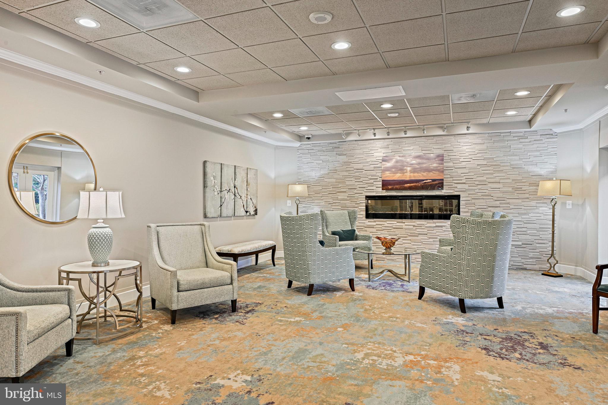 19355 Cypress Ridge Terrace, Unit 612 Leesburg, VA 20176 - Photo 42 of 65 a living room with furniture a flat screen tv and kitchen view