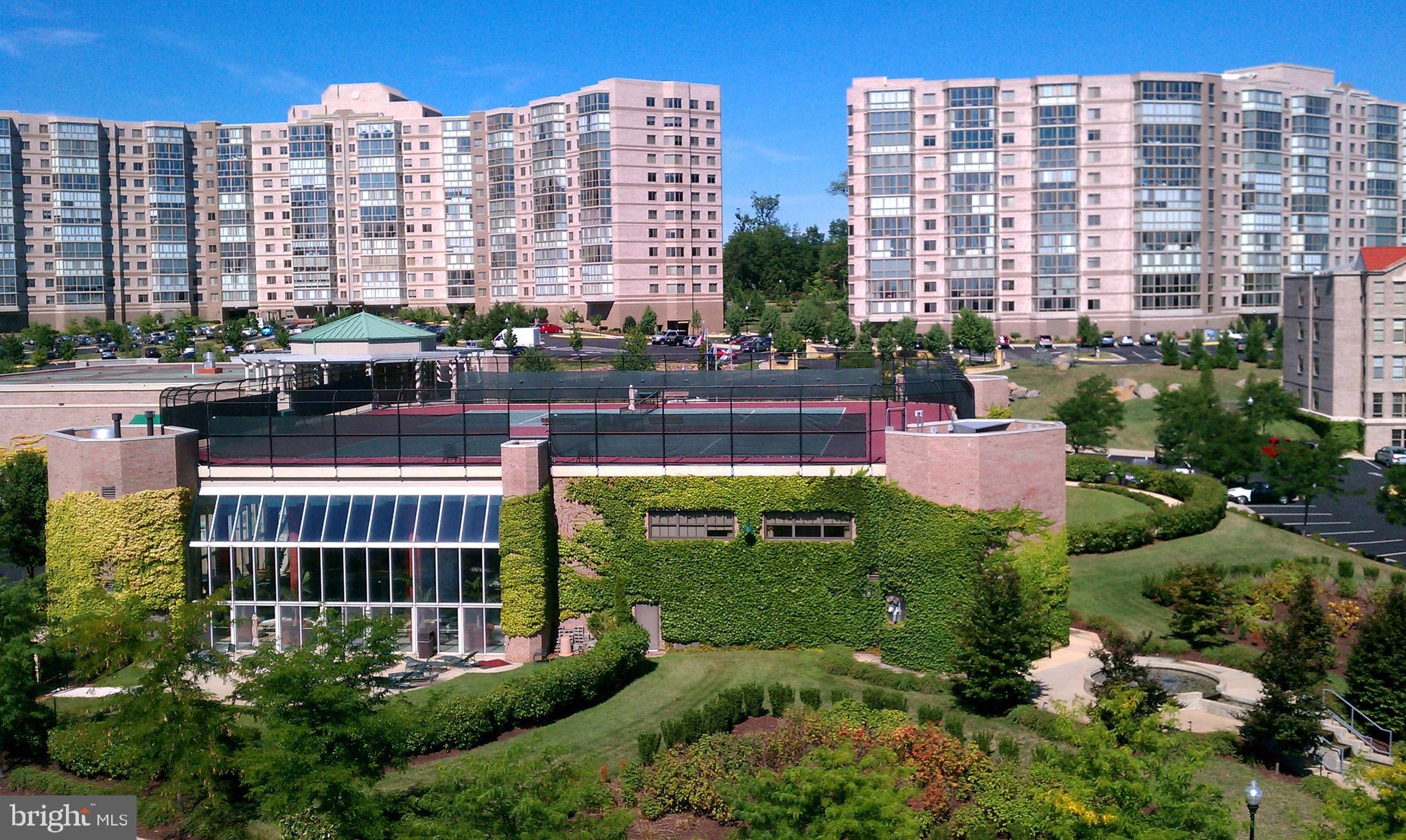 19355 Cypress Ridge Terrace, Unit 612 Leesburg, VA 20176 - Photo 48 of 65 a view of a tall building and a yard