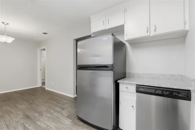 a kitchen with a refrigerator and cabinets