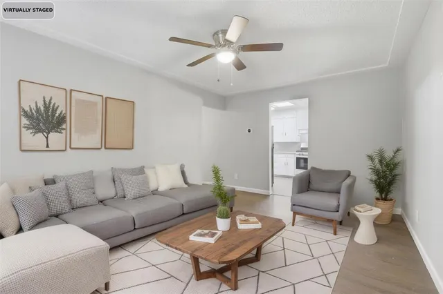 a living room with furniture and a potted plant