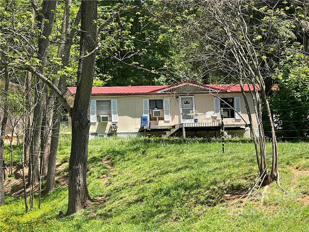 47 Little Creek Road Clyde, NC 28721 - Photo 1 of 2 a house with green field in front of it
