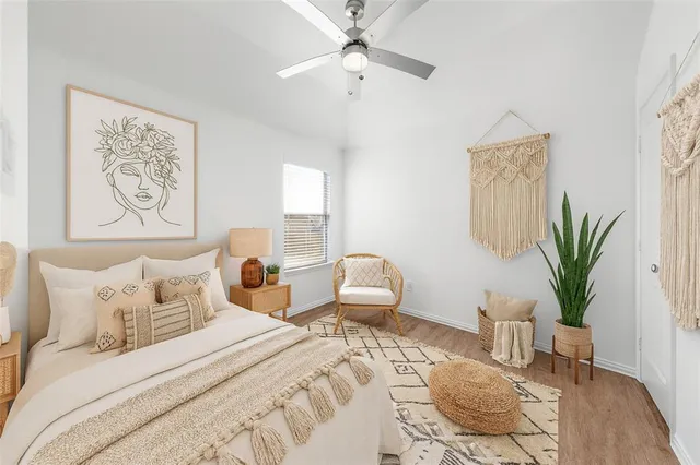 a bedroom with a large bed and a potted plant