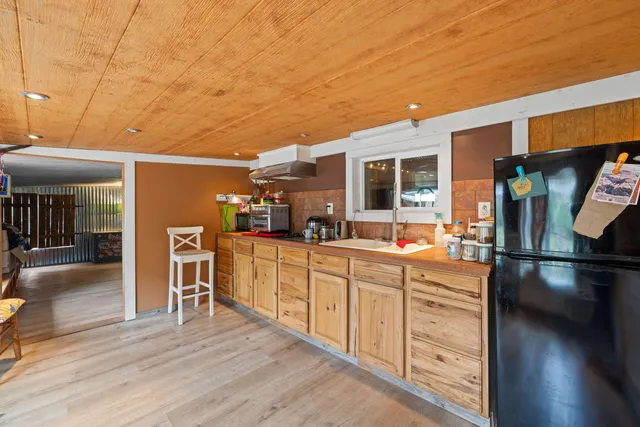 a kitchen with stainless steel appliances granite countertop a refrigerator and a stove top oven