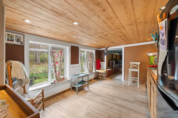 a living room with furniture a flat screen tv and a floor to ceiling window