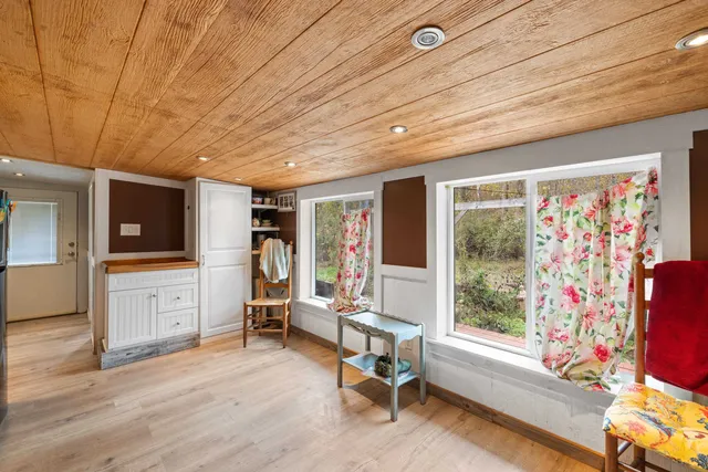 a view of a livingroom with workspace and a window
