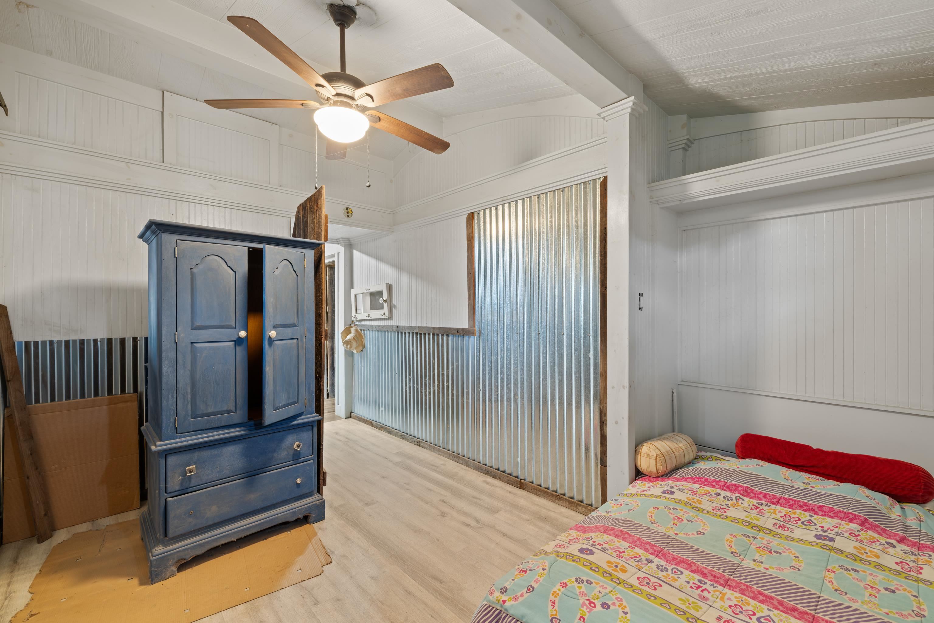 3441 West Midland Trail Lexington, VA 24450 - Photo 27 of 43 a bedroom with a bed and a chandelier