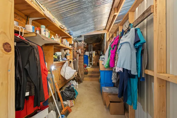 a view of walk in closet with clothes