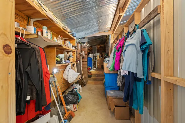a view of walk in closet with clothes