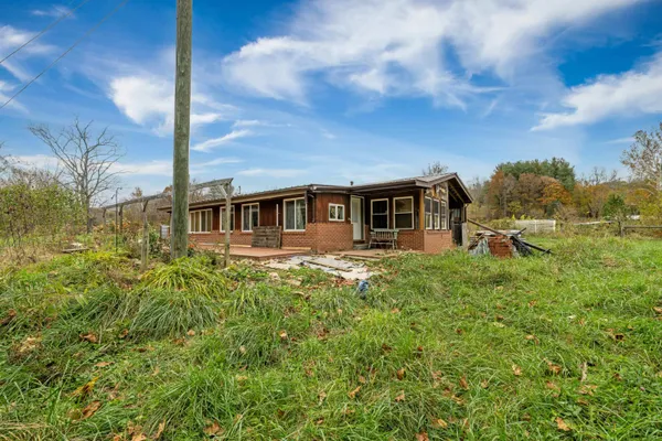a view of a house with a backyard