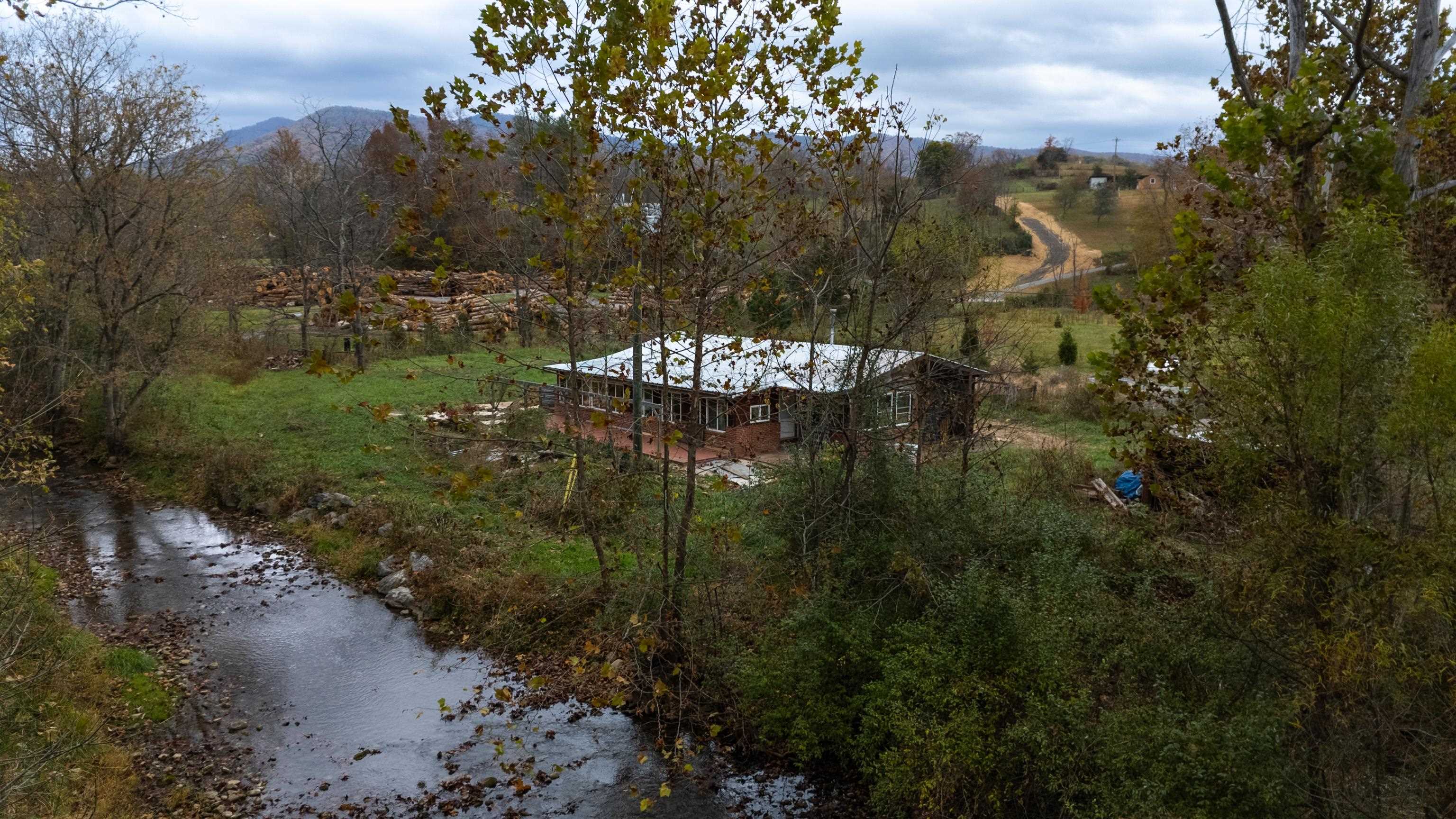 3441 West Midland Trail Lexington, VA 24450 - Photo 4 of 43 a view of a lake with a building in the background