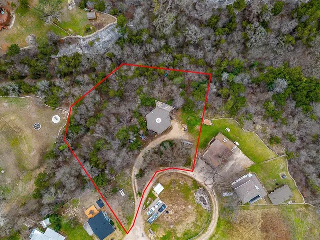 a aerial view of a house with a yard and fountain