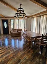 a view of a livingroom with furniture wooden floor chandelier