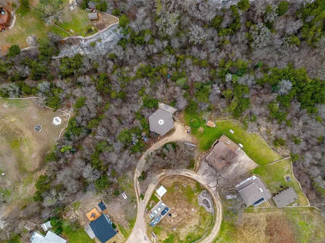 a aerial view of a house with a yard and fountain