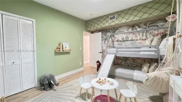 a spacious bedroom with a large bed and a window