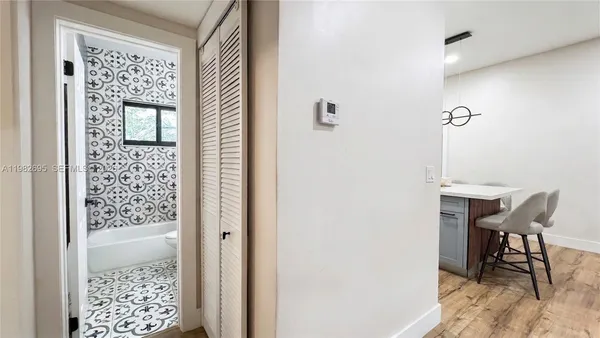 a spacious bedroom with a bed and a large mirror