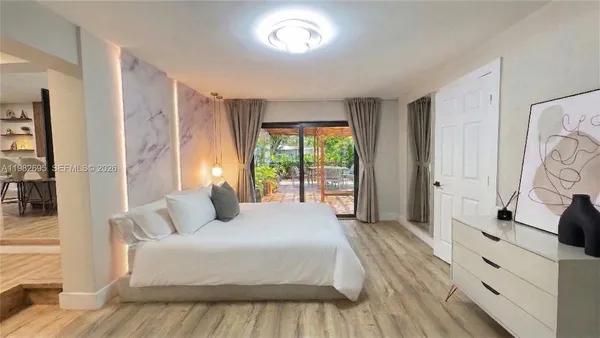a view of a bathroom with wooden floor and a bathroom