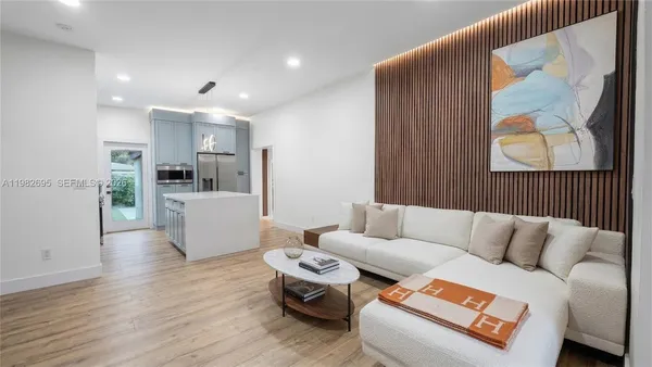 a kitchen with kitchen island a sink appliances and cabinets