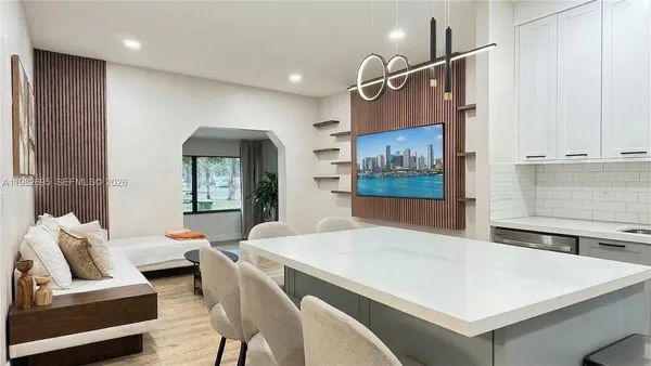 a kitchen with a table chairs refrigerator and cabinets