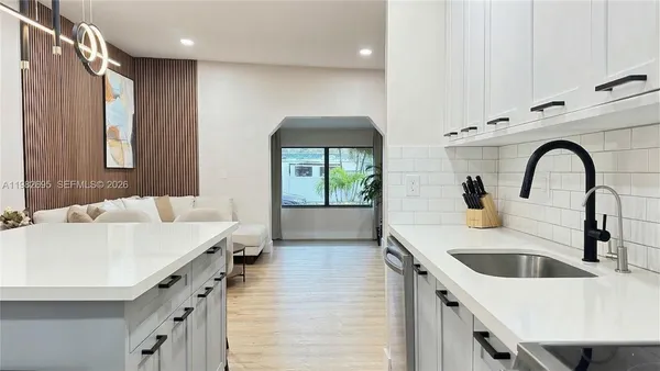 a kitchen with a sink and a refrigerator