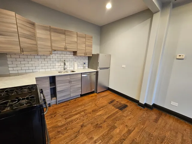 a kitchen with stainless steel appliances granite countertop a stove and a sink