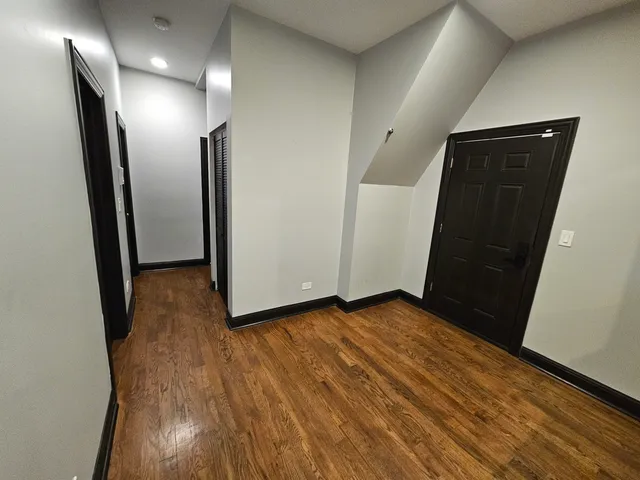 a view of hallway with wooden floor