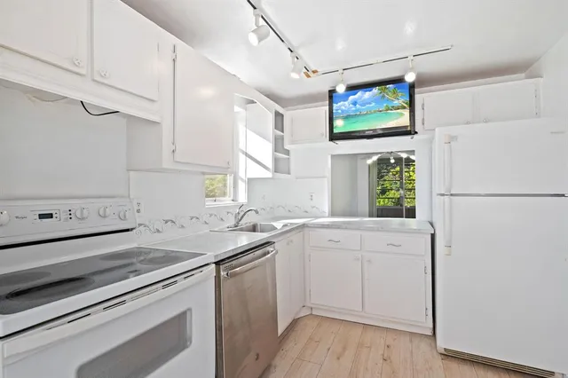 a view of empty room with wooden floor and window