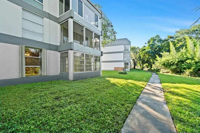 an aerial view of residential houses with yard