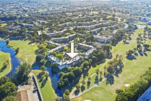 a view of a house with pool and chairs