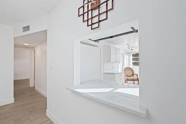 a view of a room that has a bed and a window in it