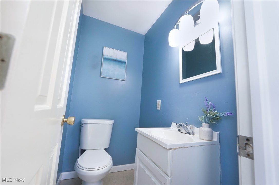 2674 Smith Road Fairlawn, OH 44333 - Photo 23 of 31 Bathroom featuring toilet, tile patterned flooring, baseboards, and vanity