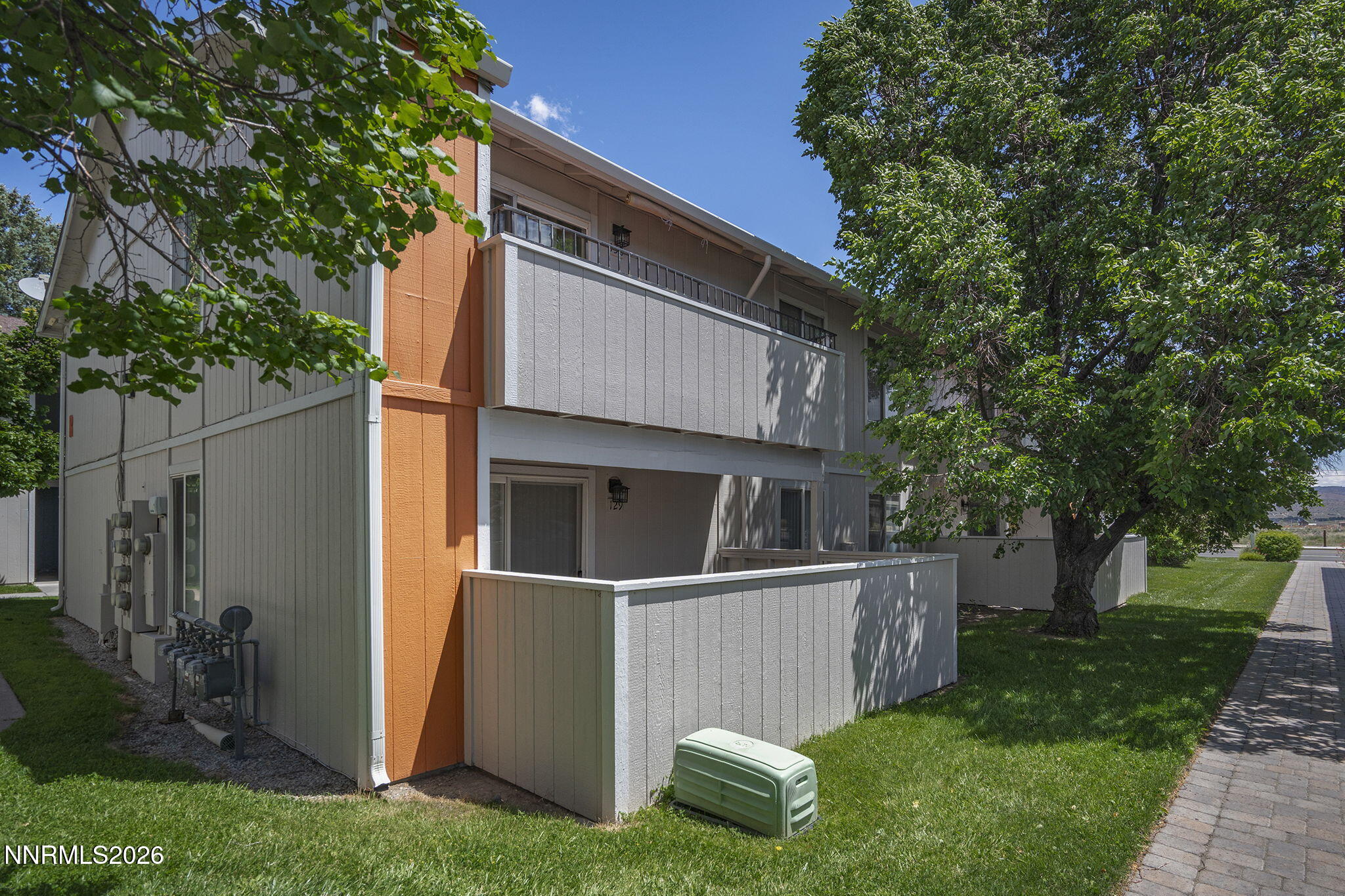 400 South Saliman Road, Unit 129 Carson City, NV 89701 - Photo 11 of 15 a view of backyard with large tree and wooden fence