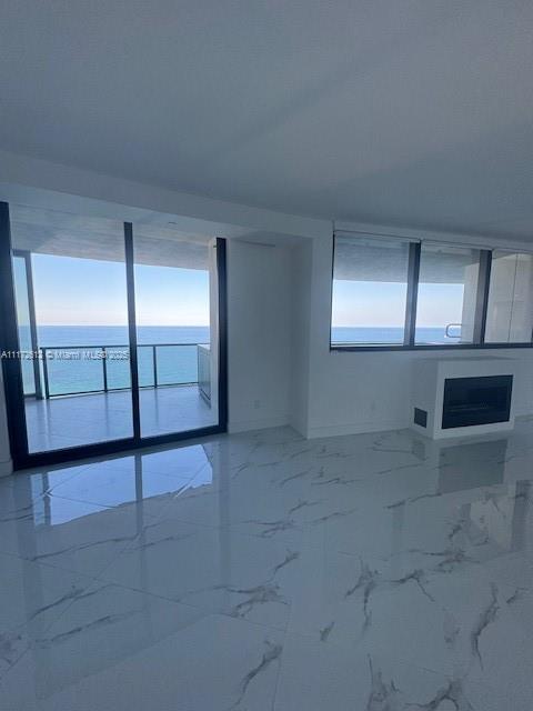18555 Collins Avenue, Unit 2905 Sunny Isles Beach, FL 33160 - Photo 12 of 40 an empty room with glass door and glass door