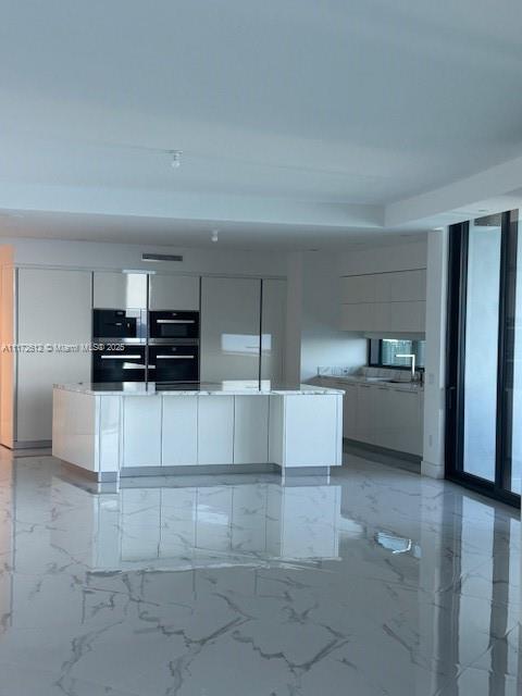 18555 Collins Avenue, Unit 2905 Sunny Isles Beach, FL 33160 - Photo 14 of 40 a view of kitchen with cabinets and microwave
